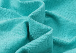 Close-up view of the premium mint green cotton fabric texture from the Hellstar Path to Paradise streetwear hoodie.