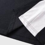 Close-up view of the premium fabric and stitching detail on a black and white Hellstar printed sports T-shirt.
