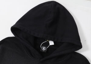 Detailed view of the Hellstar Racer Hooded Vintage Black hoodie focusing on the hood and brand tag.