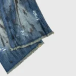 Hellstar raw edge jeans featuring premium blue distressed denim fabric with a distinctive frayed hem finish.