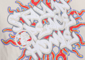 Close-up graphic detail of the Hellstar Records beige t-shirt featuring a vibrant screen-printed vintage design.