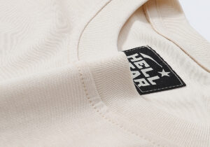 Close-up view of the interior neck label on the premium 100% cotton beige Hellstar Records vintage washed t-shirt.