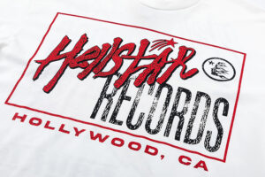 Close up of the Hellstar Records Crazy Tee featuring the red and black graphic print on a white shirt background.