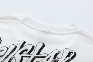 Close up view of the ribbed neckline and graphic screen print detail on a white Hellstar Records Crazy T-Shirt.