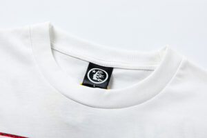 Detailed view of the Hellstar Records Crazy Tee white cotton fabric featuring the official branded neck label