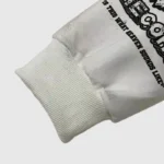 Detail view of the white Hellstar Records hoodie sleeve featuring premium fabric and black screen printed text.