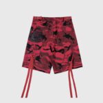 Back view of Hellstar red camo cargo shorts with decorative leg straps and pockets for urban streetwear fashion.