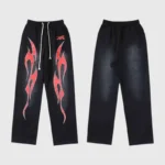 Hellstar Red Flame sweatpants featuring bold graphic flame prints on black fleece fabric with an adjustable drawstring waist.