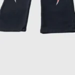 Close-up view of the leg detail on the black Hellstar Red Flame sweatpants featuring red flame graphics near the hem.