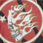 Close-up of the Hellstar Red Sports Logo featuring a flaming skull graphic on a breathable mesh long sleeve fabric.