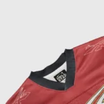 A close-up view of the collar and brand label on a red Hellstar sports logo mesh long sleeve athletic tee shirt.
