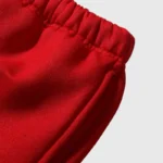 Close up of the premium soft red fabric on the Hellstar Print Logo Sweatpants featuring an elasticated waistband.
