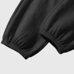 Close-up view of the elastic cuffed leg hem of the black premium Hellstar Sample streetwear sweatpants.