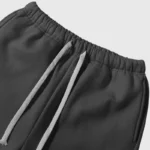 Close-up view of the adjustable drawstring waistband on a pair of dark gray Hellstar sample sweatpants design.