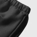 Close-up view of the elastic waistband and premium fabric on the black Hellstar Sample Sweatpants streetwear bottoms.