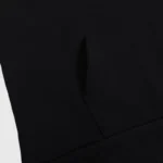 Close-up view of the black fabric and kangaroo pocket on the Hellstar Sample Tracksuit premium pullover hoodie.