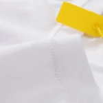 Close-up view of the premium white cotton fabric and stitching detail on the Hellstar Savior printed T-shirt.