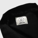 Close-up of the official Hellstar logo printed on a neckline tag inside the Saviors T-shirt for brand authentication.