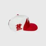 Hellstar Shark Teeth snapback hat in off-white and red featuring embroidered branding and unique jagged shark tooth design.