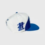 Hellstar Shark Teeth Snapback hat featuring an off-white crown and bold royal blue brim with signature H embroidery.