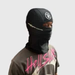 Model wearing a black Hellstar Shiesty Balaclava ski mask with white logo branding, showing a sleek winter accessory.