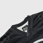 A detailed view of the black Hellstar Skull Drop Print long sleeve shirt, highlighting the neck collar and brand tag.