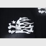 Black Hellstar T-shirt featuring a white screen-printed graphic of a flaming skull and crossbones with a small star.