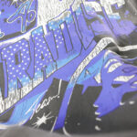 A close-up detail of the graphic print on the Hellstar Skull Helmet T-Shirt featuring blue and purple typography.