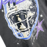 Close-up graphic of the Hellstar Skull Helmet T-shirt featuring a detailed distressed skull inside a football helmet