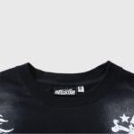 Close-up view of the black Hellstar Skull T-Shirt neckline featuring the brand logo tag and white graphic details