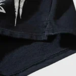 Close-up detail of the premium black fabric and graphic screen print on the Hellstar Snap Black street style shorts.