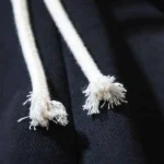 Close-up view of the white drawstring detail on the black fabric of Hellstar Snap Black Shorts streetwear apparel.