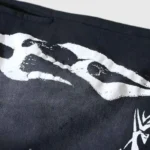 Close-up of the black Hellstar Snap shorts showing the detailed white graphic print design on premium fabric.