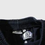 Close-up view of the interior waist label and branding tag on a pair of black Hellstar Snap streetwear shorts.