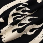 Close-up view of the premium black cotton fabric featuring the iconic white Hellstar Sport gel logo design.