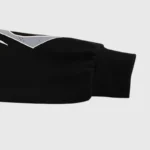 Close-up of the black Hellstar Sport tracksuit sleeve featuring a grey gel logo graphic detail against a plain background.