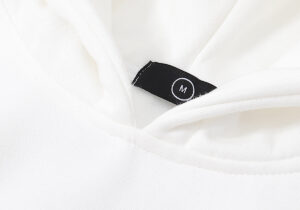 Detail of the white Hellstar Sport hoodie featuring a black size M label inside the neck collar on premium fabric.
