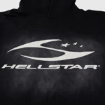 Close-up view of the iconic white Hellstar Sport logo graphic screen printed on a premium black cotton fleece hoodie.