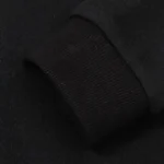 Close-up view of the premium fabric and ribbed cuff texture on a black Hellstar Sport Logo Hoodie for streetwear.
