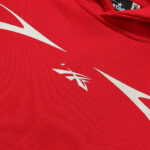Close-up of the red Hellstar Sport pullover hoodie featuring a prominent white screen-printed graphic detail.