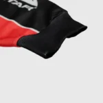 Close-up of the Hellstar Sport Style Long Sleeve Tee featuring a branded black and red fabric with ribbed cuff detail.