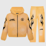 Men's Hellstar Sport yellow tracksuit featuring a zip-up hoodie and matching sweatpants with vintage flame graphics.