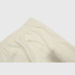 Close-up of the beige Hellstar Sports sweatpants highlighting the elastic waistband and premium heavyweight fleece fabric.