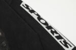 A detailed close-up of the distressed white SPORTS text branding on the sleeve of a black Hellstar Sports 96 crewneck.