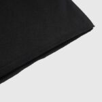 Close up view of the black cotton fabric texture from the premium Hellstar Sports black sweater garment detail.