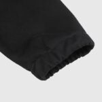 Close-up view of the ribbed cuff detail on a black Hellstar Sports sweater showing the fabric texture and quality.
