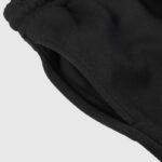 Close-up view of the functional deep side welt pocket on the Hellstar Sports black heavyweight fleece sweatpants.