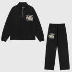 Hellstar Sports black unisex tracksuit featuring a premium cotton half-zip jacket and matching drawstring sweatpants.