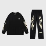 Black Hellstar Sports tracksuit set featuring a long-sleeve crewneck top and matching graphic sweatpants for men.