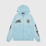 Front view of the blue Hellstar Sports zip-up hoodie featuring flame sleeve graphics and branded logo details.